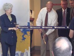 Lois Morris holds the ceremonial ribbon as WVU former President James Clements cuts the ribbon